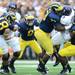 Michigan defensive tackle William Campbell and defensive end Frank Clark tie up Northwestern tailback Vernic Mark during the third quarter at Michigan Stadium on Saturday. Melanie Maxwell I AnnArbor.com